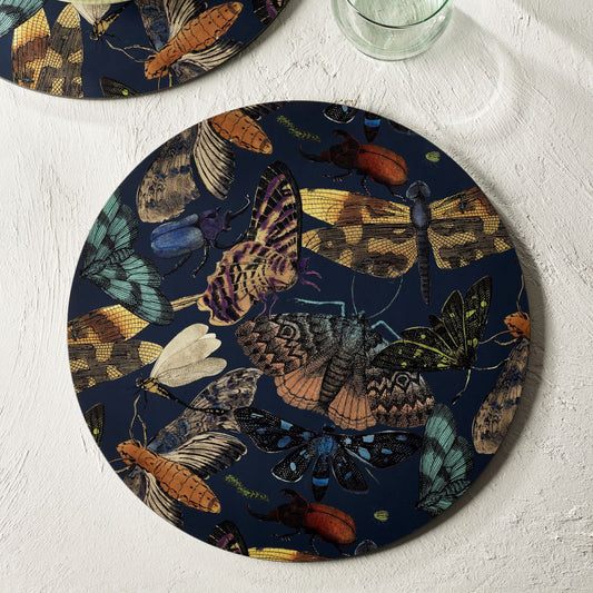 Round table placemats with detailed illustration of moths and butterflies, on a blue background, from Kew Gardens available from Vinegar Hill.