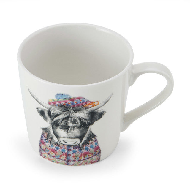 This white china mug features an illustration of a Highland cow by renowned artists Tipperleyhill. It is a head and shoulders black and white sketch of a cow wearing a colourful fairisle patterened jacket and a matching tam o' shanter with a blue fluffy bobble