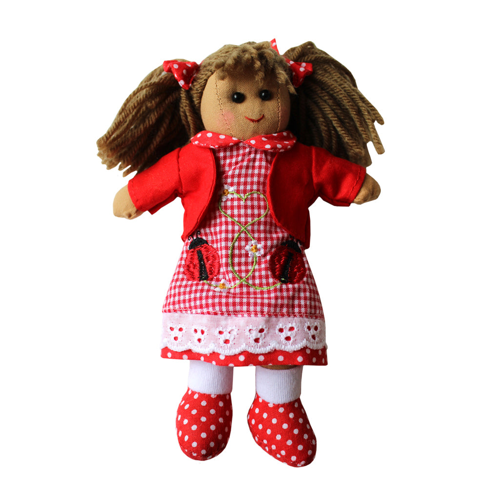 This rag doll with her hair in bunches with red bows, is by Powell Craft from Vinegar Hill. She wears a red gingham dress has a polka dot collar and hem to match her shoes and is embellished with appliquéd ladybirds and daisies. The look is completed with a red bolero jacket.