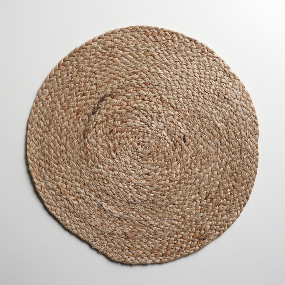 Round grey woven placemat from Vinegar Hill. Mat is circular with the jute spiralling out from the centre.